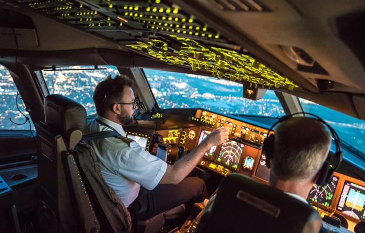 Pilots in cockpit of plane